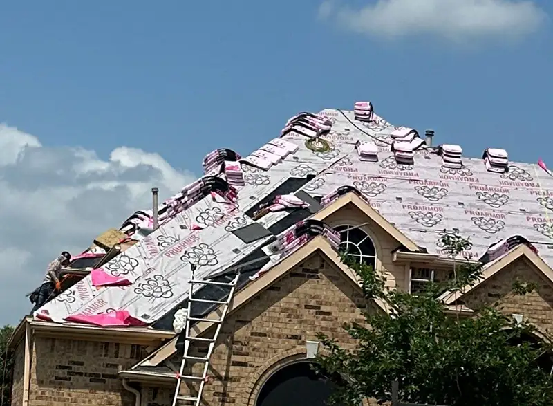 Underlayment in place and shingles distributed across the roof - Roof replacement in Plano